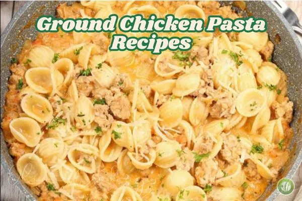 A skillet filled with orecchiette pasta and ground chicken in a creamy tomato sauce, topped with melted parmesan cheese and garnished with chopped parsley.